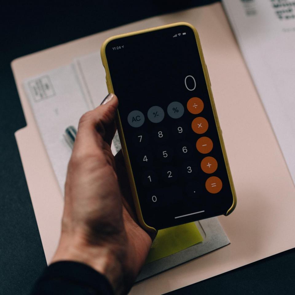 A hand holding a calculator