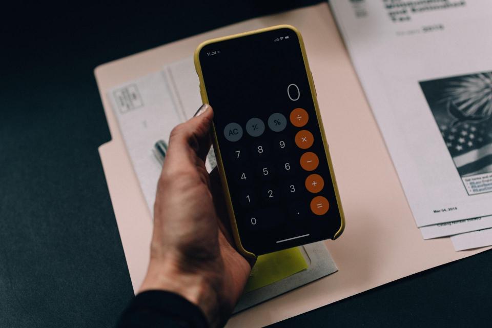 A hand holding a calculator